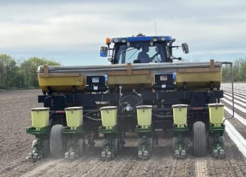 Tractor planting seeds in a field.