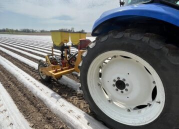 Tractor working in a plowed farm field.